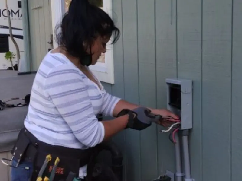 Licensed electrician wiring an exterior subpanel in Manila